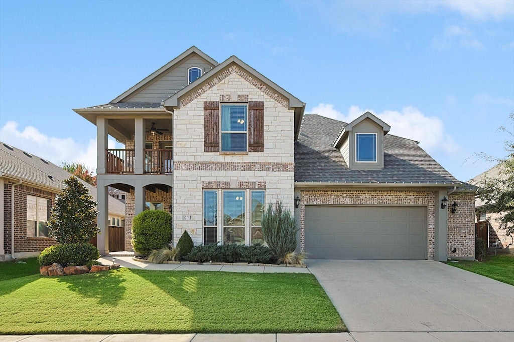 view of front of house with a balcony, a garage, and a front lawn