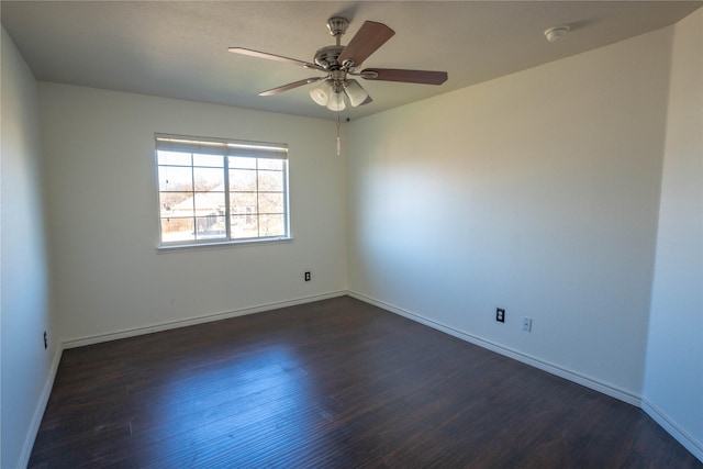 empty room with ceiling fan and dark wood-type flooring