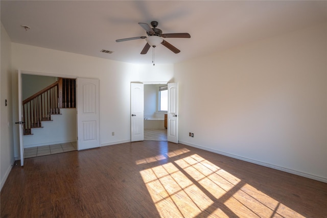 spare room featuring hardwood / wood-style flooring and ceiling fan