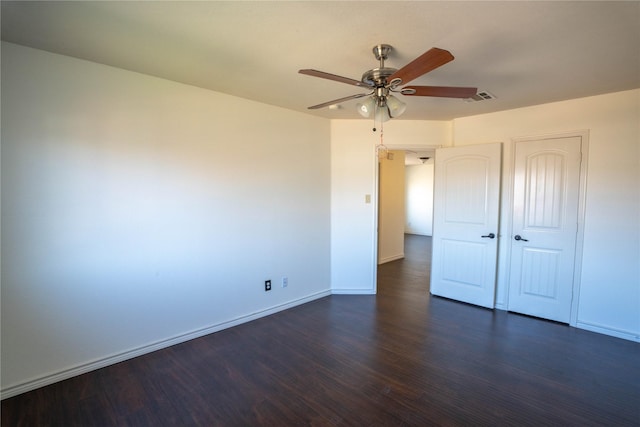 unfurnished bedroom with ceiling fan and dark wood-type flooring