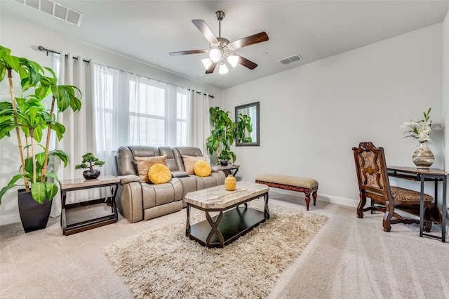 carpeted living room with ceiling fan