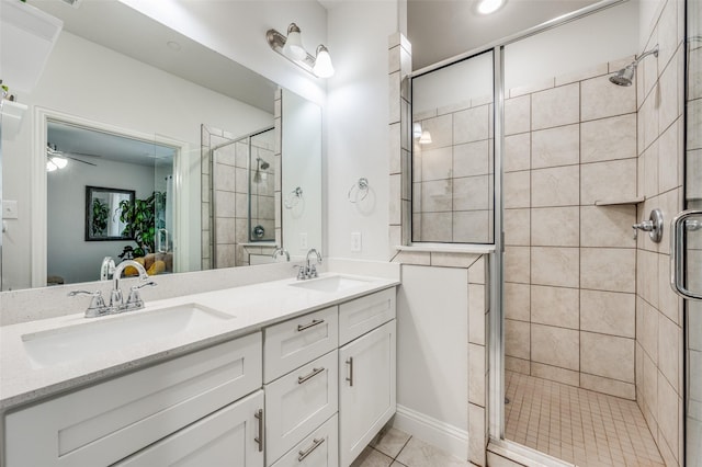 bathroom with tile patterned floors, ceiling fan, vanity, and a shower with shower door