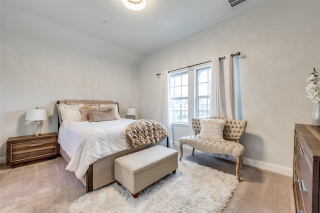 bedroom with light carpet and vaulted ceiling