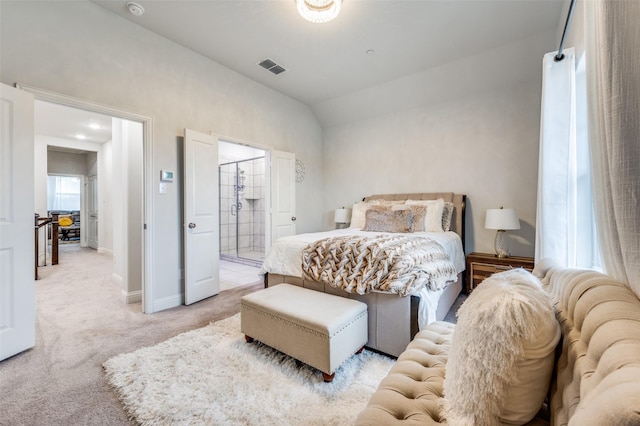 carpeted bedroom with connected bathroom and vaulted ceiling