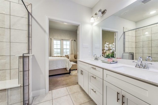 bathroom featuring tile patterned floors, a shower with door, and vanity