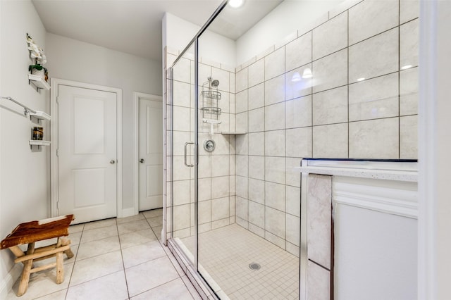 bathroom with tile patterned floors and a shower with shower door