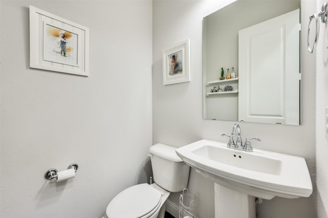 bathroom featuring toilet and sink