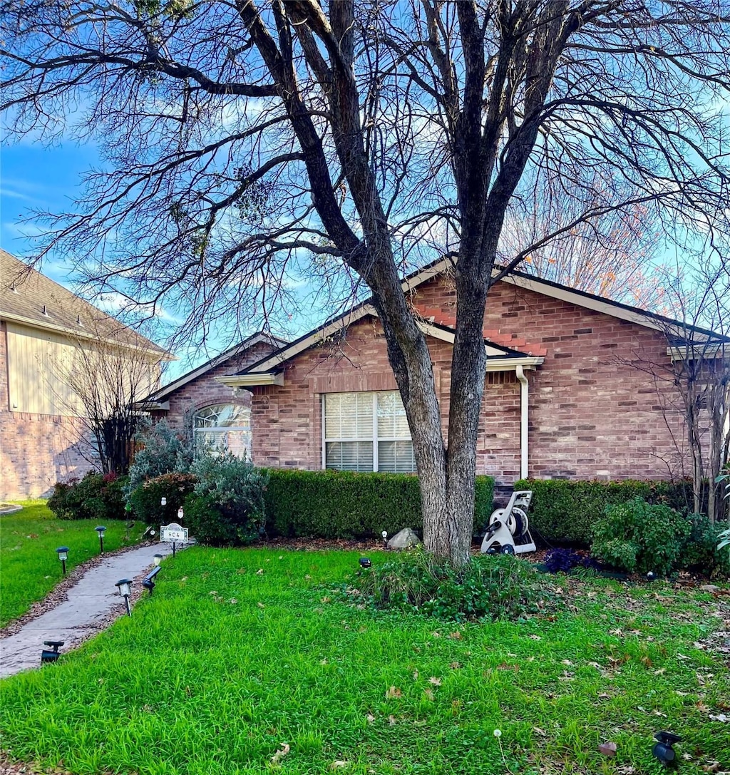 view of side of home featuring a lawn