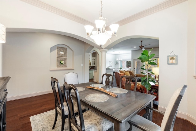 dining space with ceiling fan with notable chandelier, dark hardwood / wood-style floors, crown molding, and decorative columns