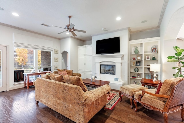 living room featuring crown molding, ceiling fan, and dark hardwood / wood-style floors