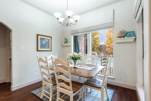 dining area featuring dark hardwood / wood-style floors, an inviting chandelier, and ornamental molding