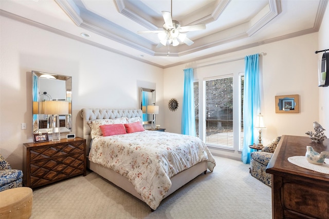 bedroom with a raised ceiling, multiple windows, ceiling fan, and access to outside