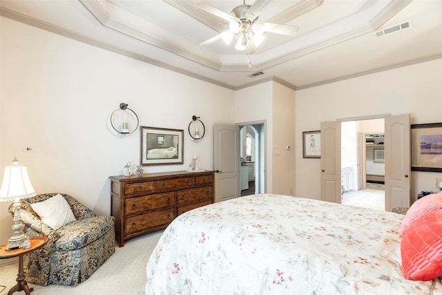 bedroom with ceiling fan, a raised ceiling, ornamental molding, and light carpet