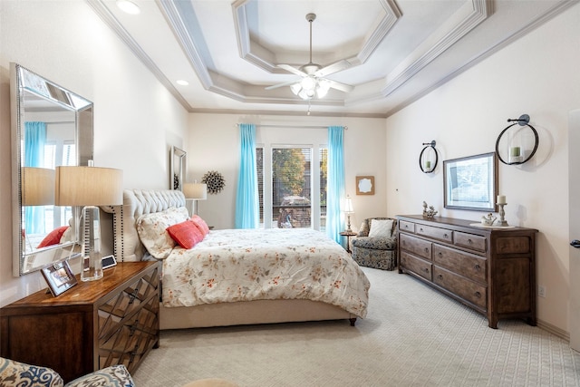 bedroom featuring a tray ceiling, crown molding, ceiling fan, and light colored carpet