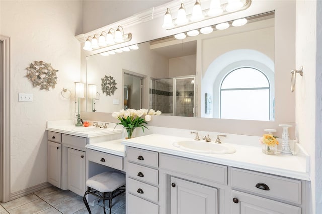 bathroom with tile patterned flooring, vanity, and a shower with shower door