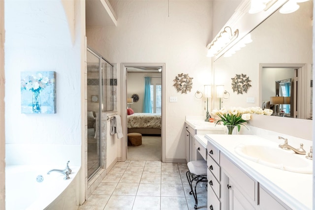 bathroom with tile patterned flooring, vanity, and independent shower and bath