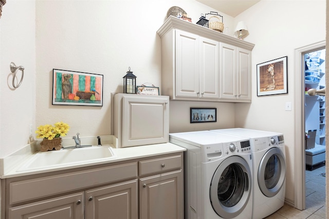 washroom featuring washer and clothes dryer, cabinets, light tile patterned floors, and sink