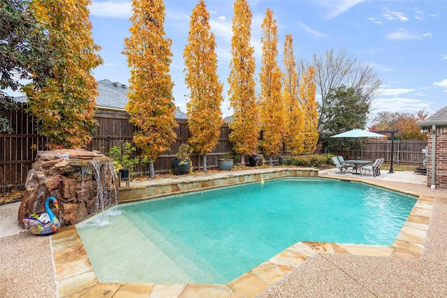 view of pool with pool water feature and a patio