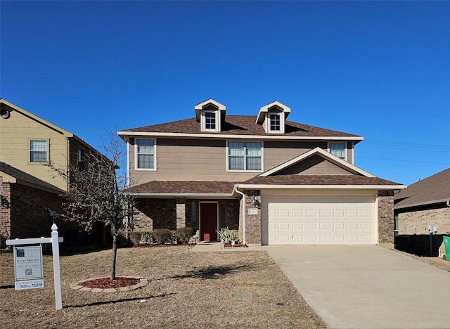 view of front of house with a garage, concrete driveway, brick siding, and roof with shingles