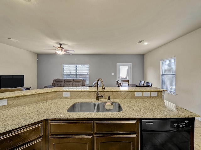 kitchen featuring ceiling fan, black dishwasher, sink, and a wealth of natural light