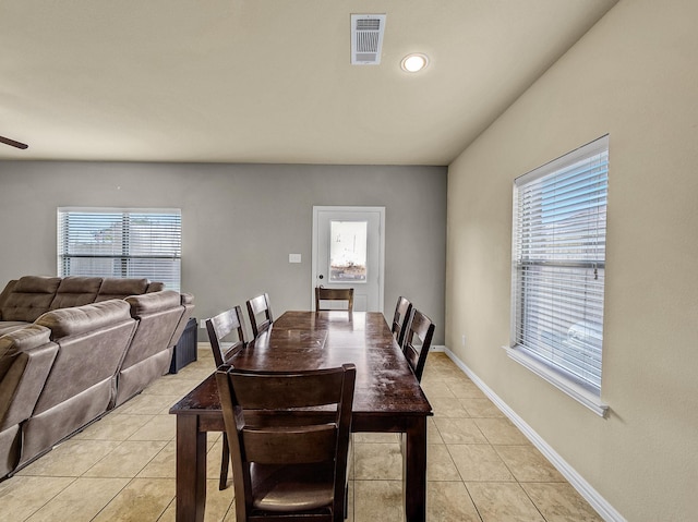 dining room featuring light tile patterned flooring, visible vents, and baseboards