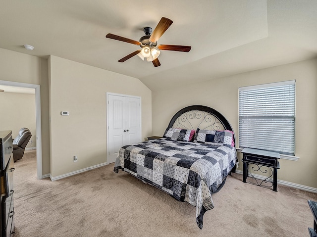 bedroom with carpet floors, ceiling fan, baseboards, and lofted ceiling