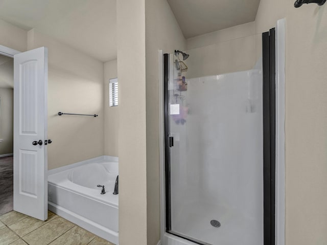 bathroom featuring a shower stall and a bath