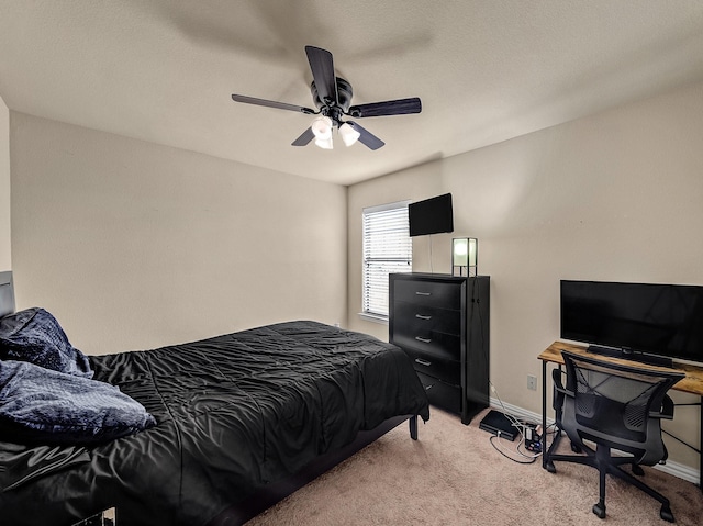 bedroom featuring baseboards, a ceiling fan, and light colored carpet