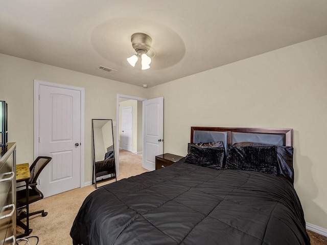 carpeted bedroom featuring baseboards, visible vents, and a ceiling fan