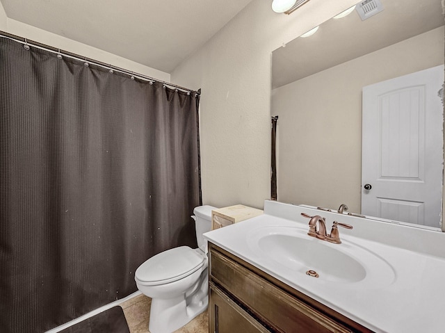 bathroom featuring vanity, tile patterned flooring, and toilet