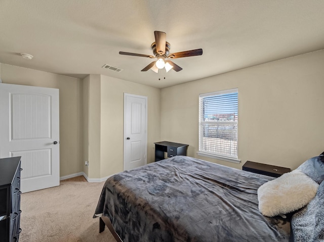 bedroom featuring visible vents, ceiling fan, light carpet, and baseboards