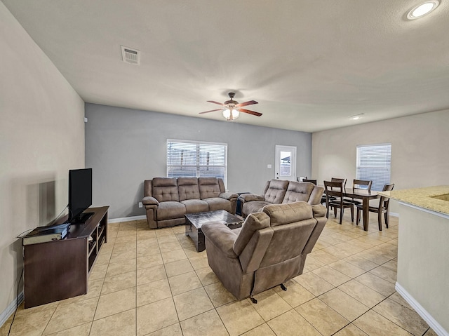 living room with light tile patterned floors and ceiling fan