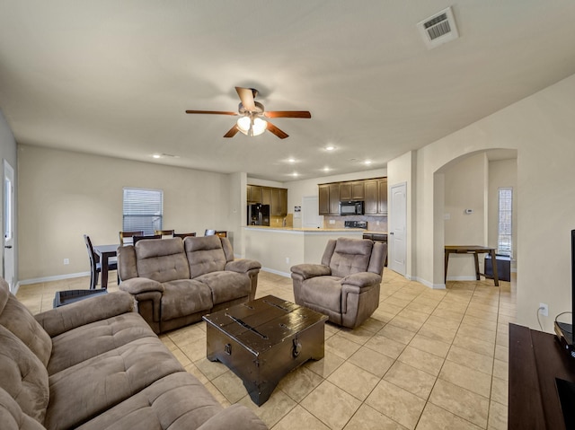 living room with light tile patterned floors and ceiling fan