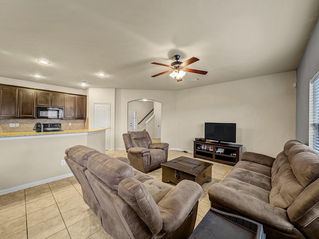 living room featuring ceiling fan and light tile patterned flooring