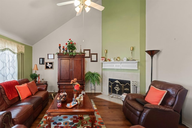 living room featuring ceiling fan, a high end fireplace, dark hardwood / wood-style flooring, and vaulted ceiling