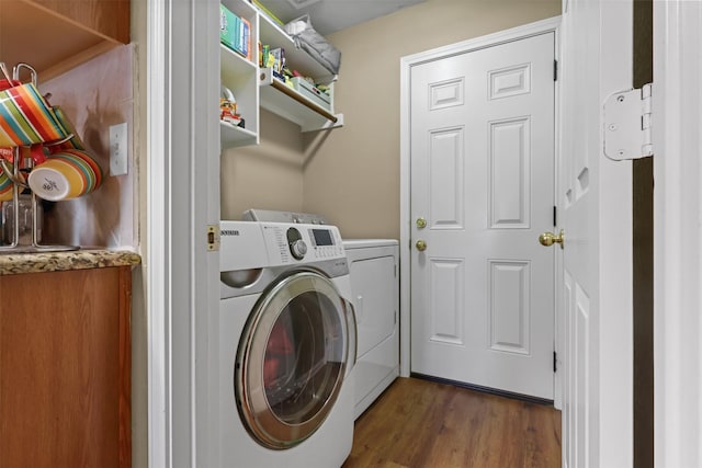 washroom featuring independent washer and dryer and dark hardwood / wood-style floors