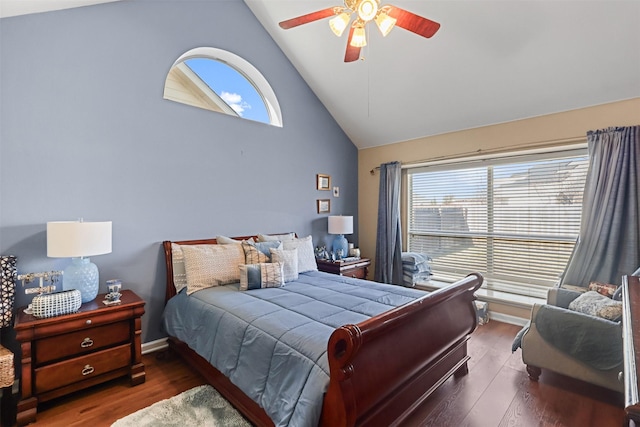 bedroom with ceiling fan, dark hardwood / wood-style flooring, and high vaulted ceiling