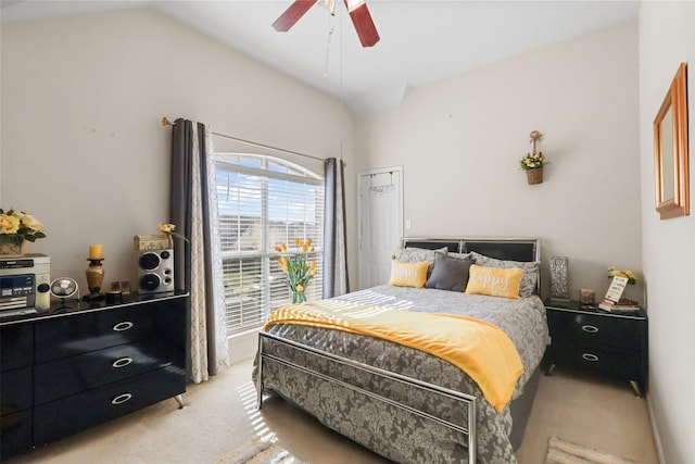 carpeted bedroom with ceiling fan and vaulted ceiling