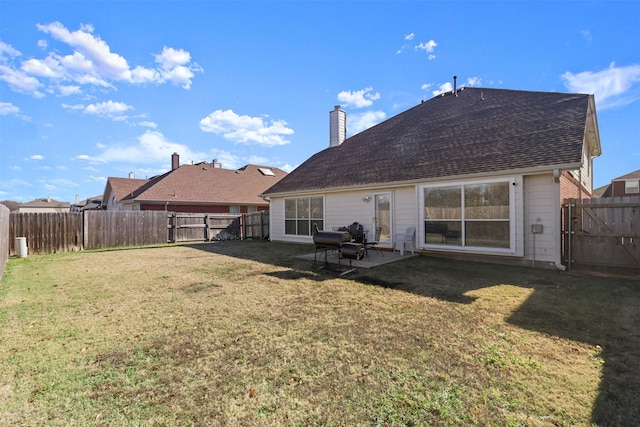 back of house featuring a patio and a lawn