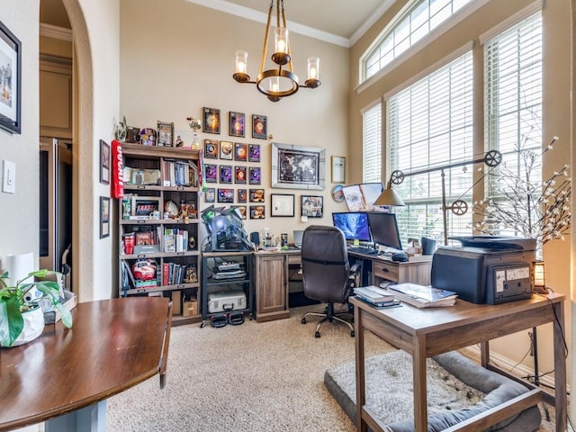 carpeted home office with a chandelier and crown molding