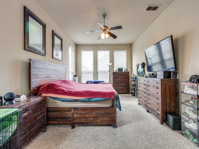 bedroom with ceiling fan and light colored carpet