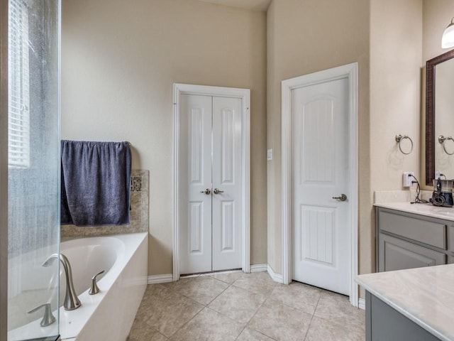 bathroom featuring a bathtub, tile patterned flooring, and vanity