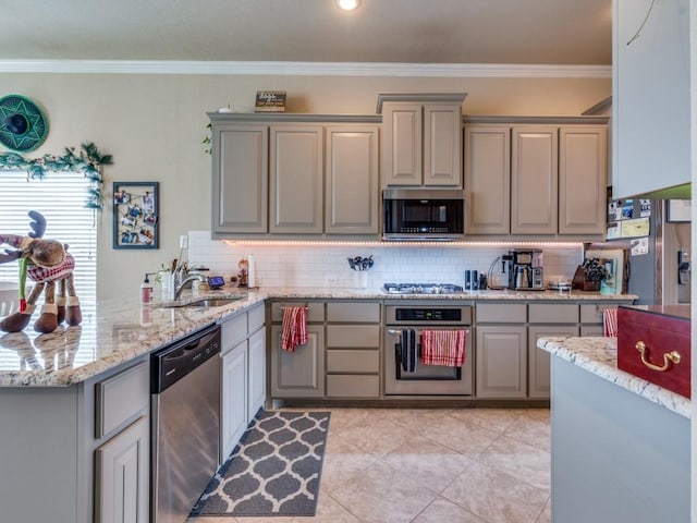 kitchen featuring decorative backsplash, sink, ornamental molding, and appliances with stainless steel finishes