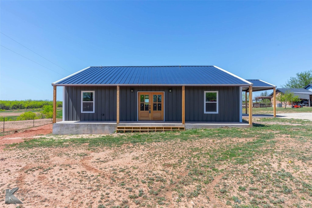 2214 Fulwiler Rd, Abilene, TX 79601 - view of front of house with board and batten siding, french doors, and metal roof