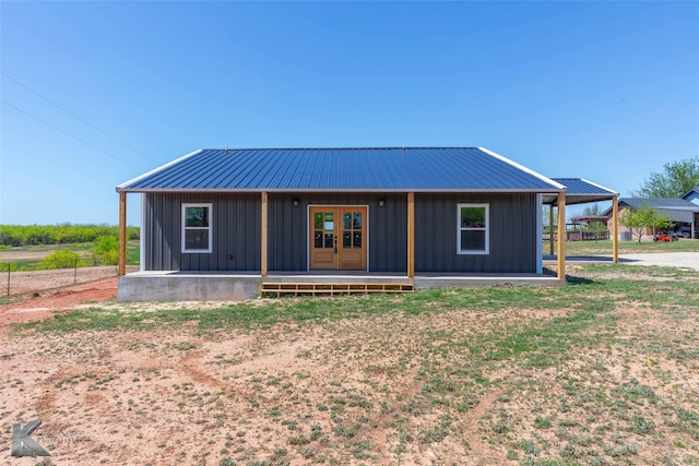 2214 Fulwiler Rd, Abilene, TX 79601 - view of front of house with board and batten siding, french doors, and metal roof