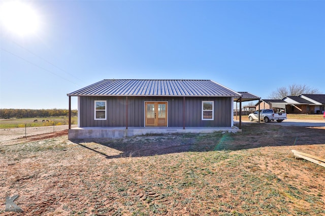 exterior space with french doors and a carport