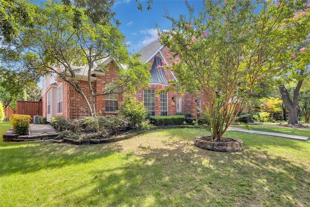 obstructed view of property with fence, a front lawn, and brick siding