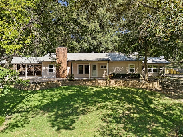 view of front facade with a patio and a front yard