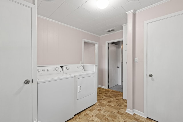 laundry area featuring washer and clothes dryer and ornamental molding