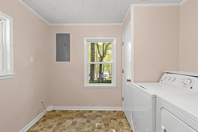 laundry room featuring crown molding, washing machine and clothes dryer, electric panel, and wood walls